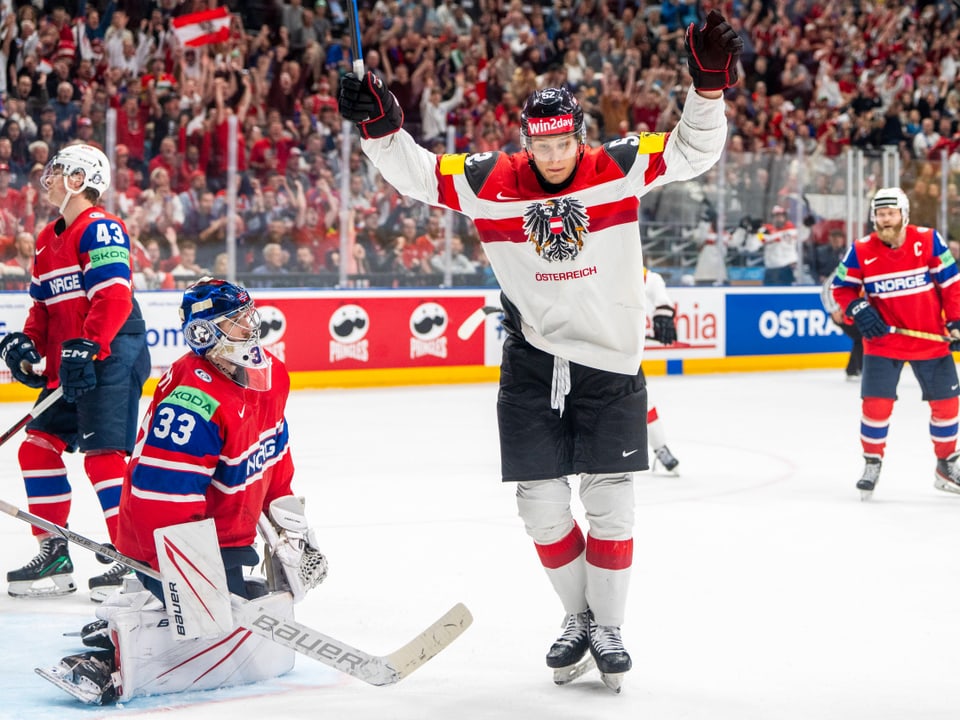 An ice hockey player celebrates a goal during a game against Norway.