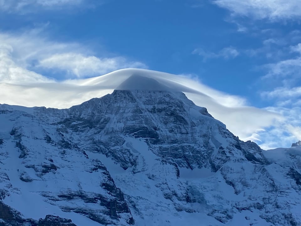 Wolken in Hutform über einem Berg