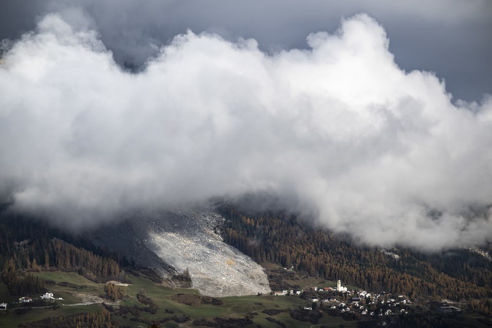 Bergdorf unter dichten Wolken.