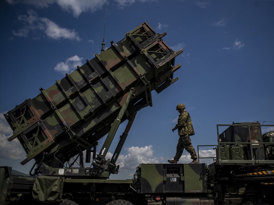 Soldat und Raketenabwehrsystem unter blauem Himmel.