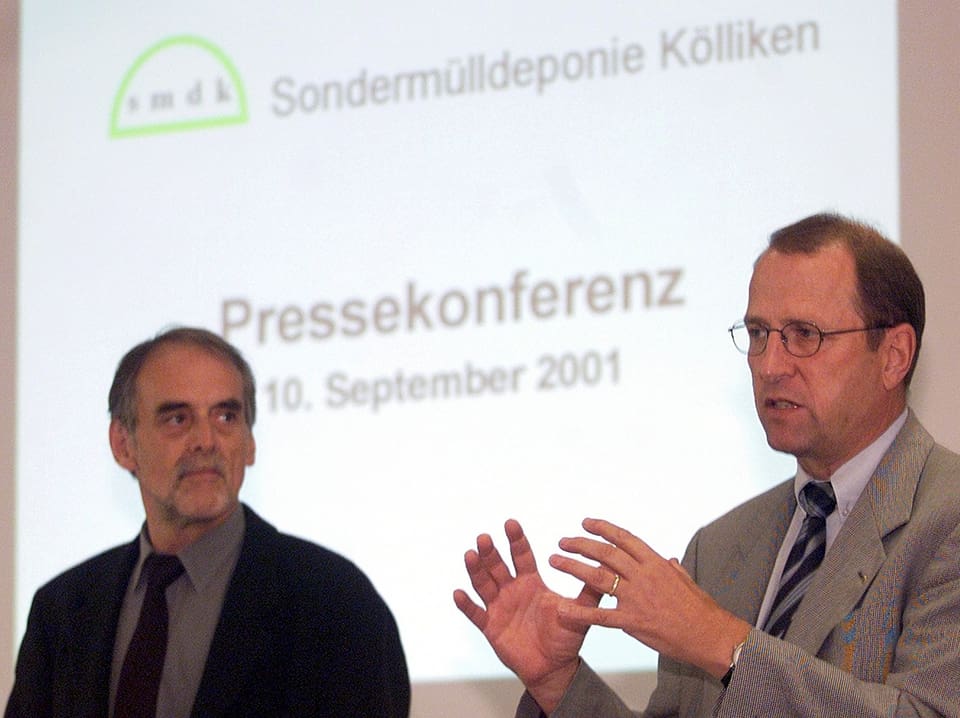 Zwei Männer vor einer Power-Point Präsentation an einer Medienkonferenz.