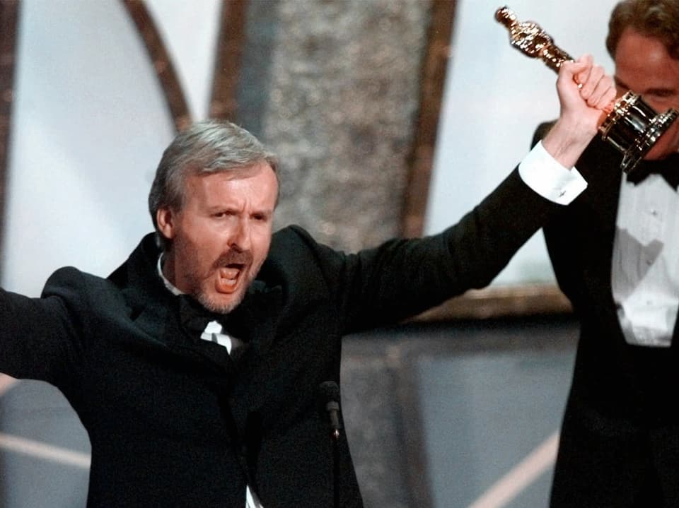 Mann jubelt mit Oscar-Statuette in der Hand.