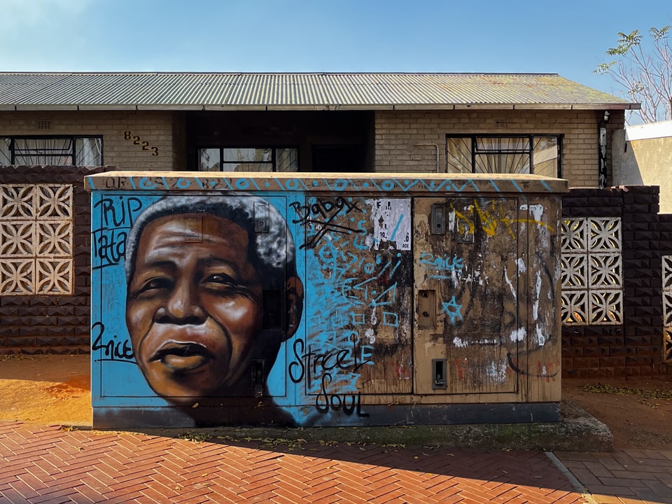 Ein gemaltes Bild von Nelson Mandela auf einer Wand.