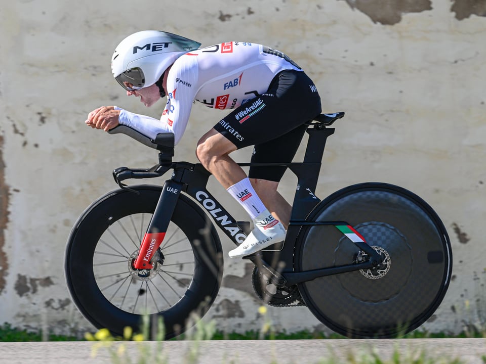 Radrennfahrer in aerodynamischer Haltung auf Zeitfahrrad.