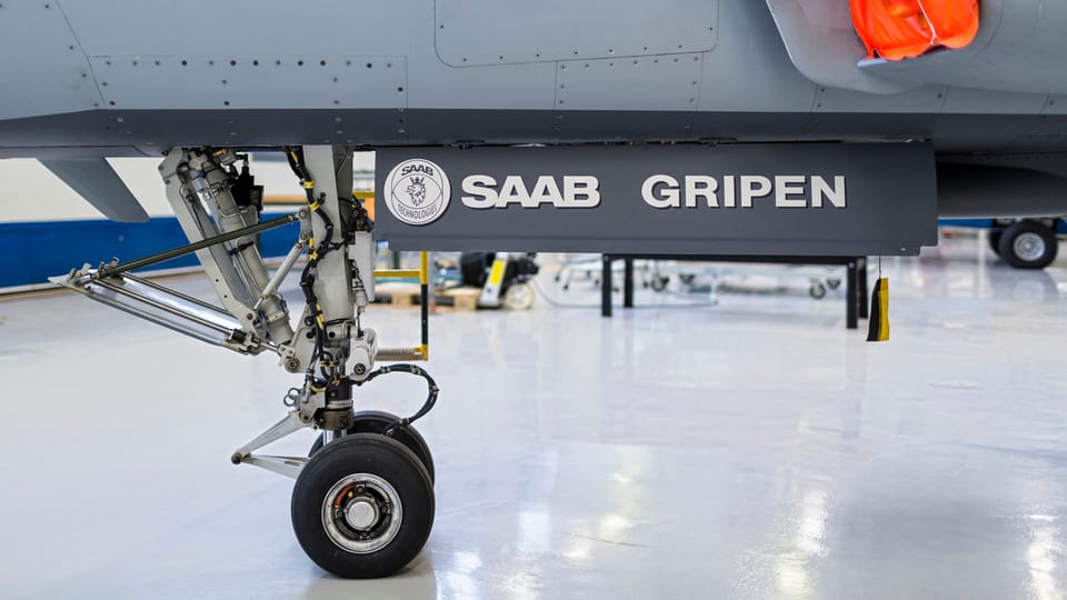 Die Räder eines Gripen, der in einem Hangar steht.