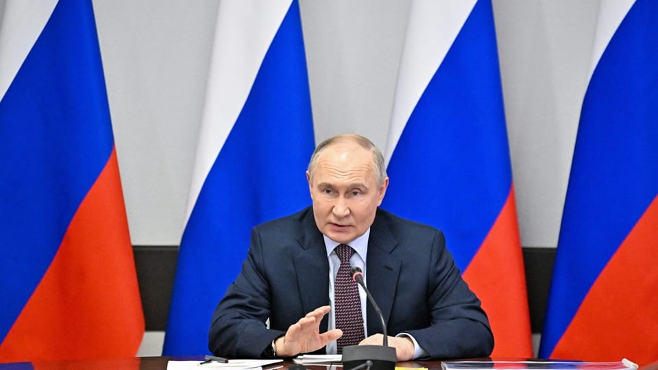 Wladimir Putin vor Russland-Flaggen