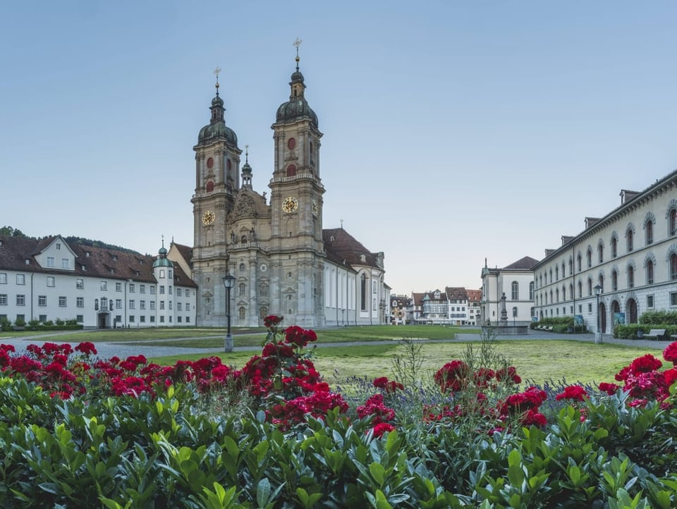 Stiftskirche St. Gallen mit üppigem Blumenbeet im Vordergrund.