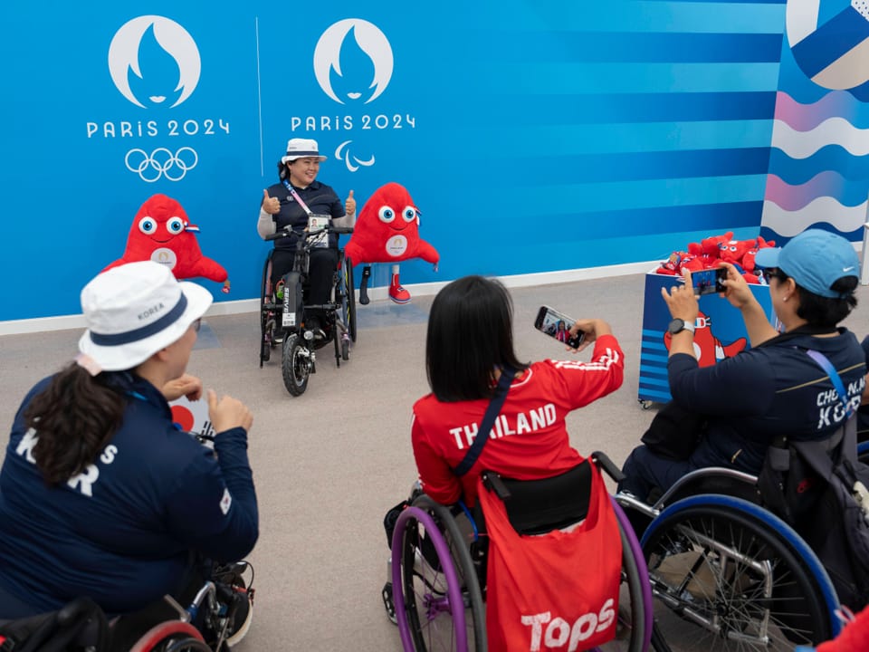 Paralympische Athleten machen Fotos bei den Olympischen Spielen Paris 2024.