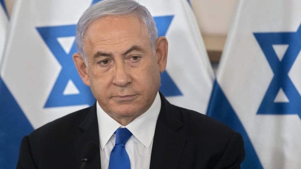 Netanyahu's face.  The Israeli flag can be seen in the background.