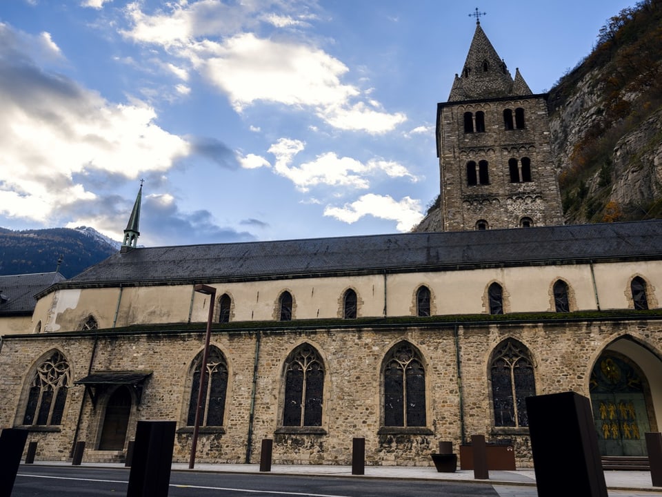 Ein langes Kirchenschiff, dahinter ein Turm. 