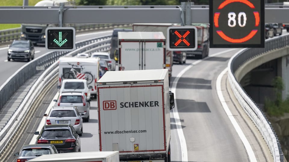 LKW and Autos im Stau op Autobahn mit Verkehrsschildern.