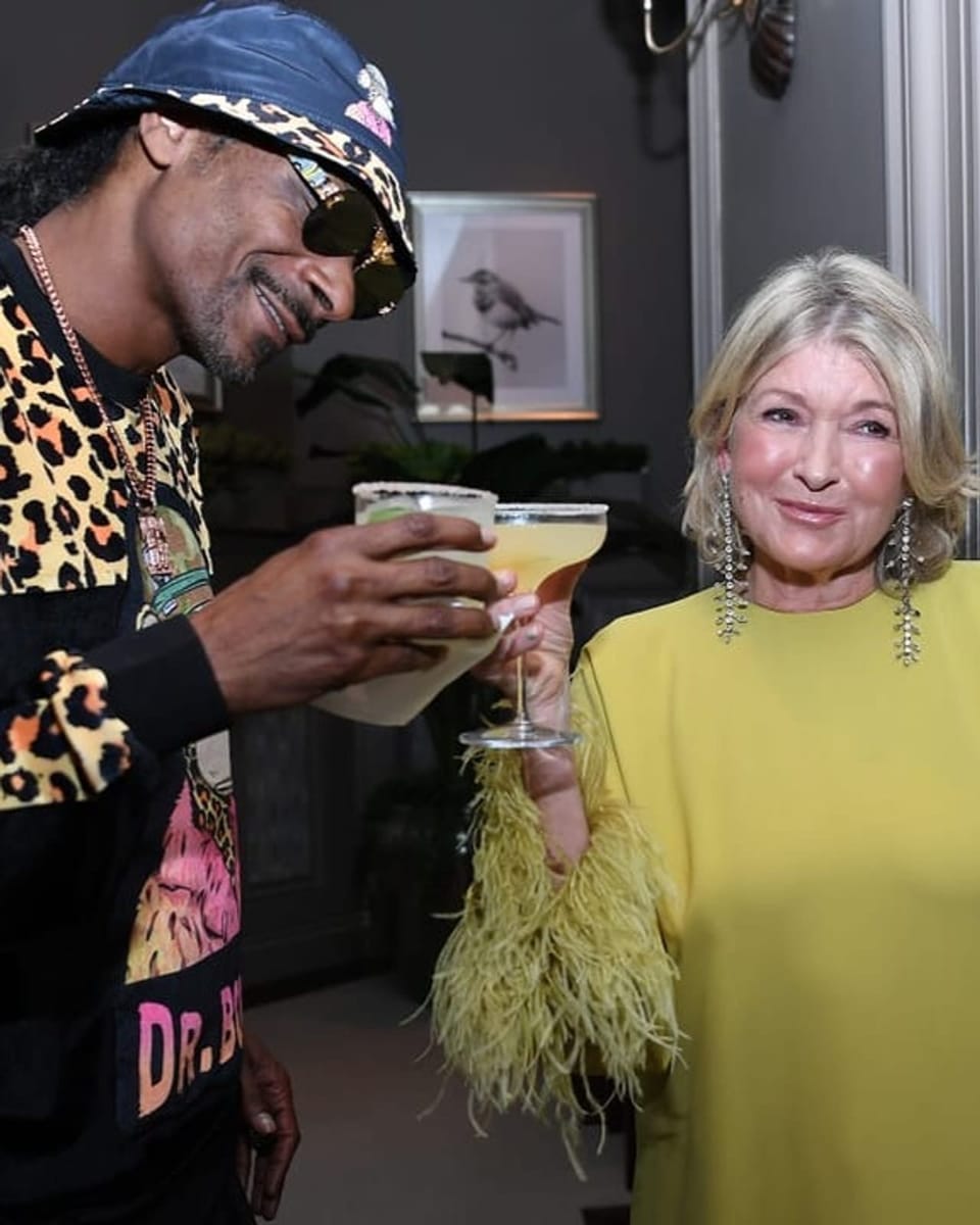 Martha Stewart und Snoop Dogg stossen mit einem Cocktail an.