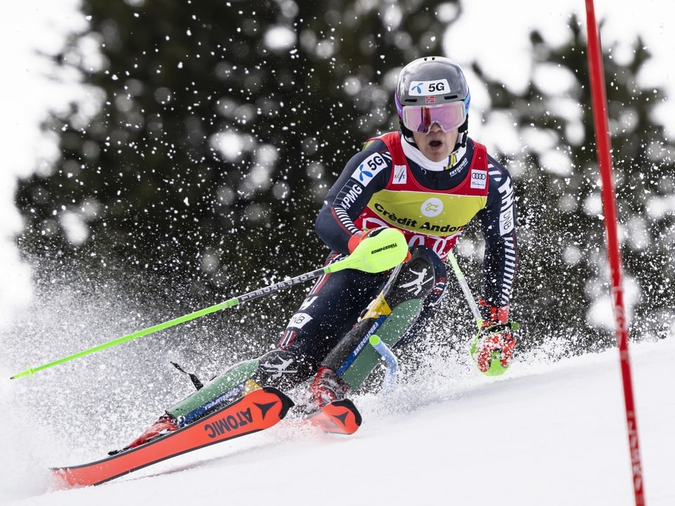 Ski racers in action on snow-covered slope.