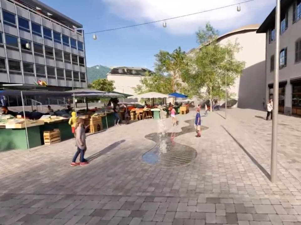 Grauer Platz, leicht begrünt mit Wasserfontänen.