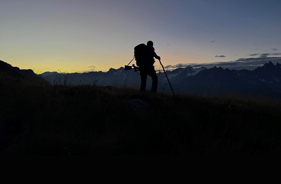 Schatten eines Wanderers bei Sonnenuntergang in den Bergen.