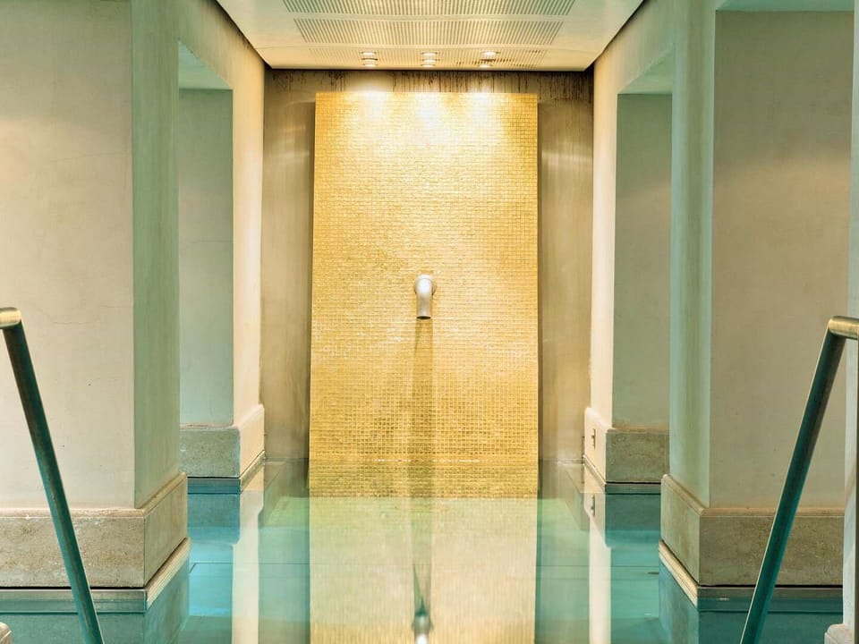 Ein luxuriöses, modernes Bad mit beigen Wänden und schöner Beleuchtung.