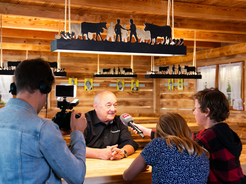 Zwei Kinder werden beim Interviews gefilmt.