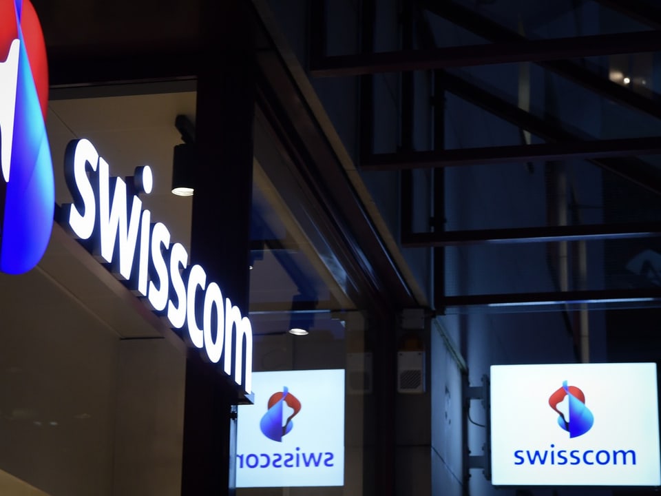 Swisscom-Schilder bei Nacht.