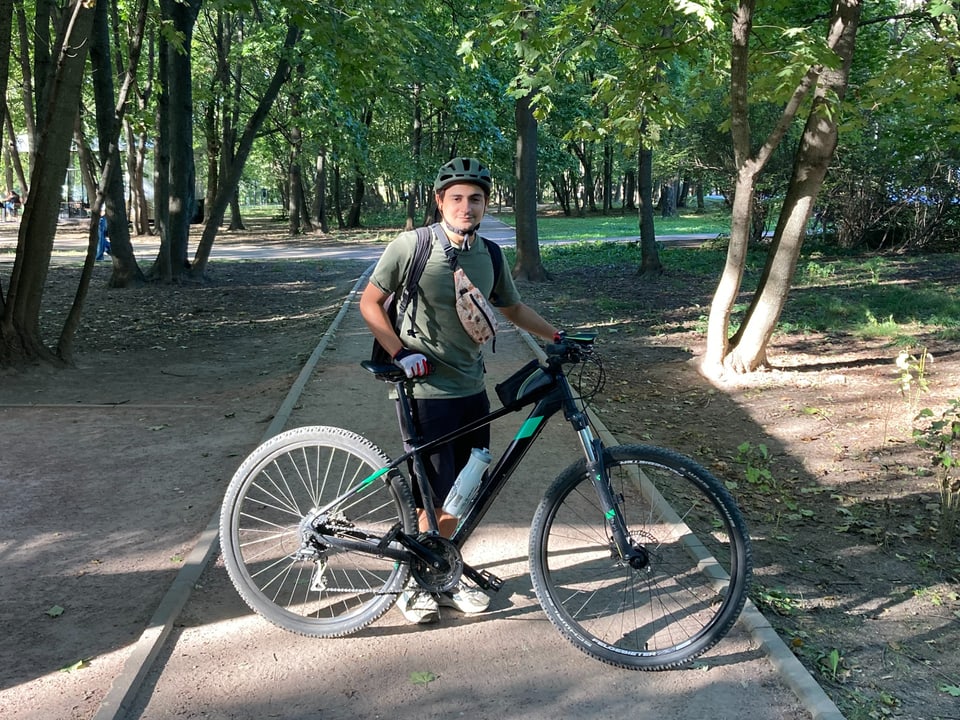 Mann mit Fahrrad im Park.