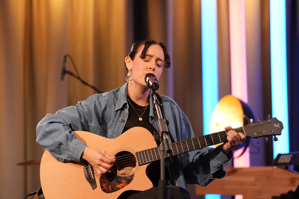 Eine Frau spielt auf einer Gitarre.