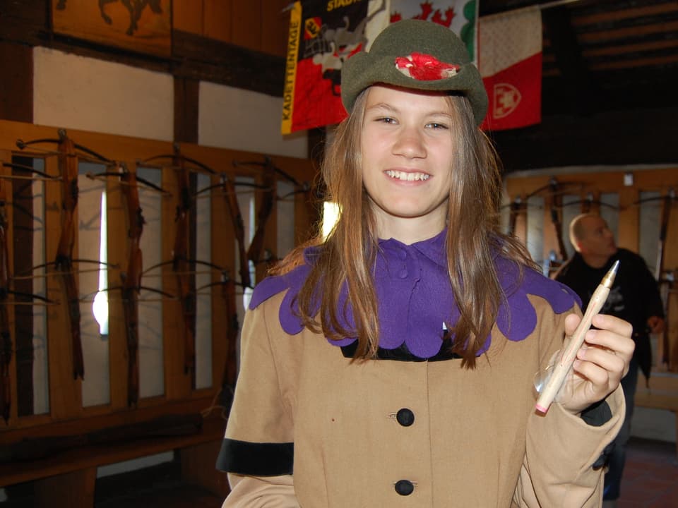 Junge Frau in historischer Kleidung mit Armbrust-Bolzen.