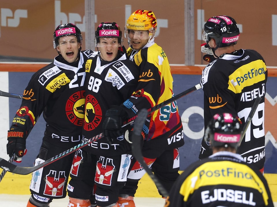 Eishockeyspieler jubeln und umarmen sich auf dem Eis.