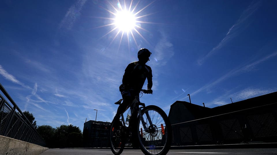 Ein Velofahrer im Gegenlicht.