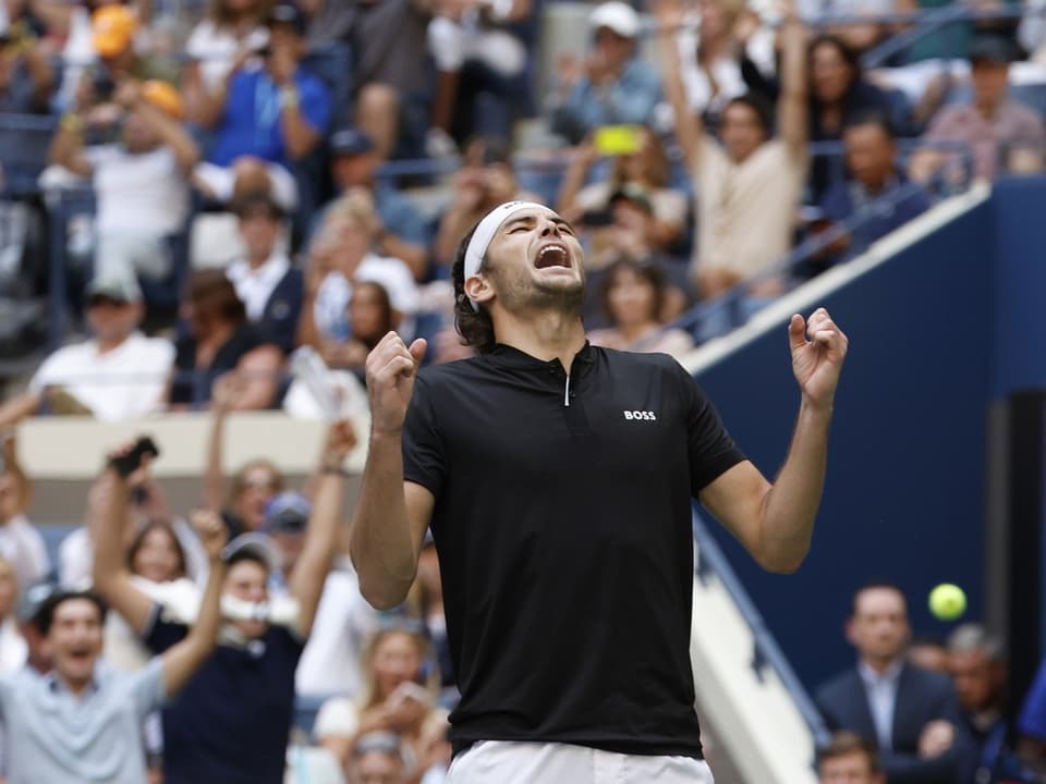 Tennisspieler jubelt auf dem Platz.