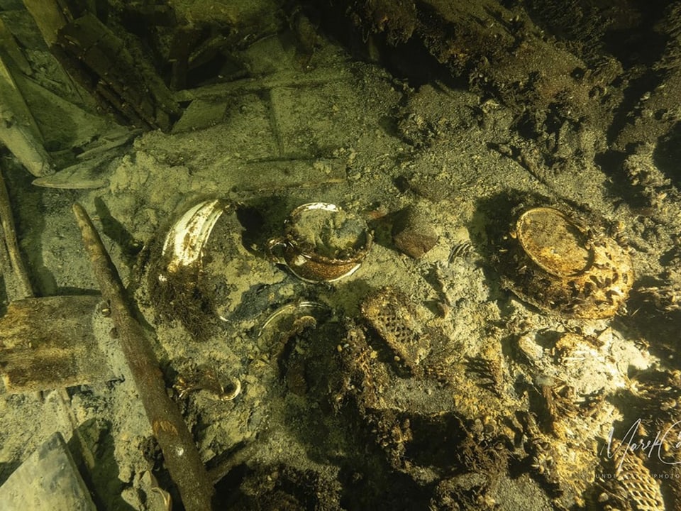 Underwater shot of shipwreck with debris and engines.