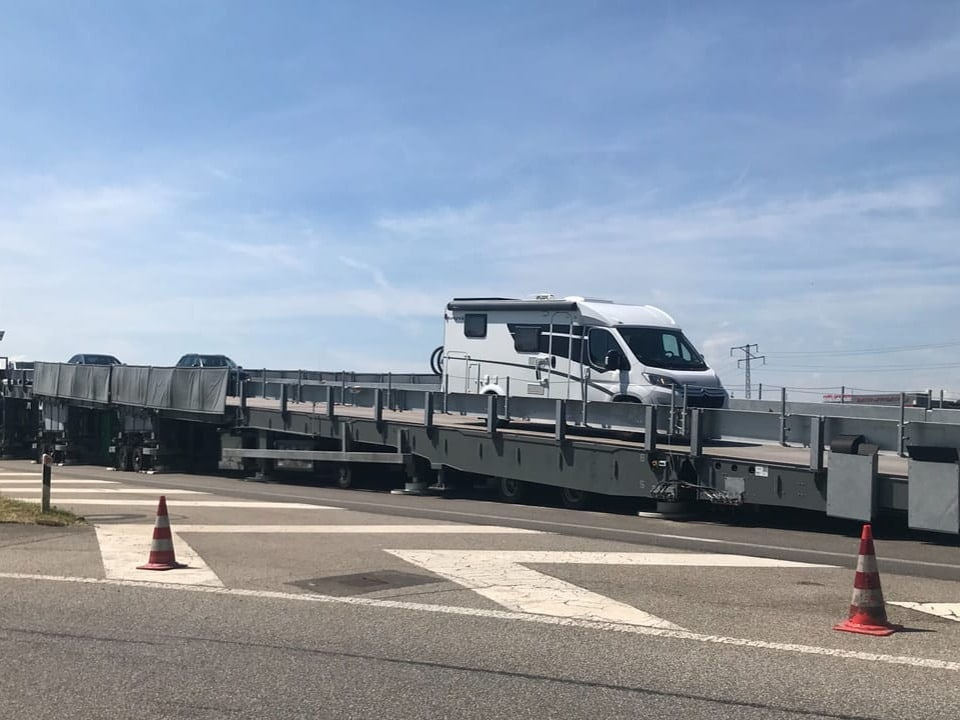 Wohnmobil auf einem Zugwagen transportiert.