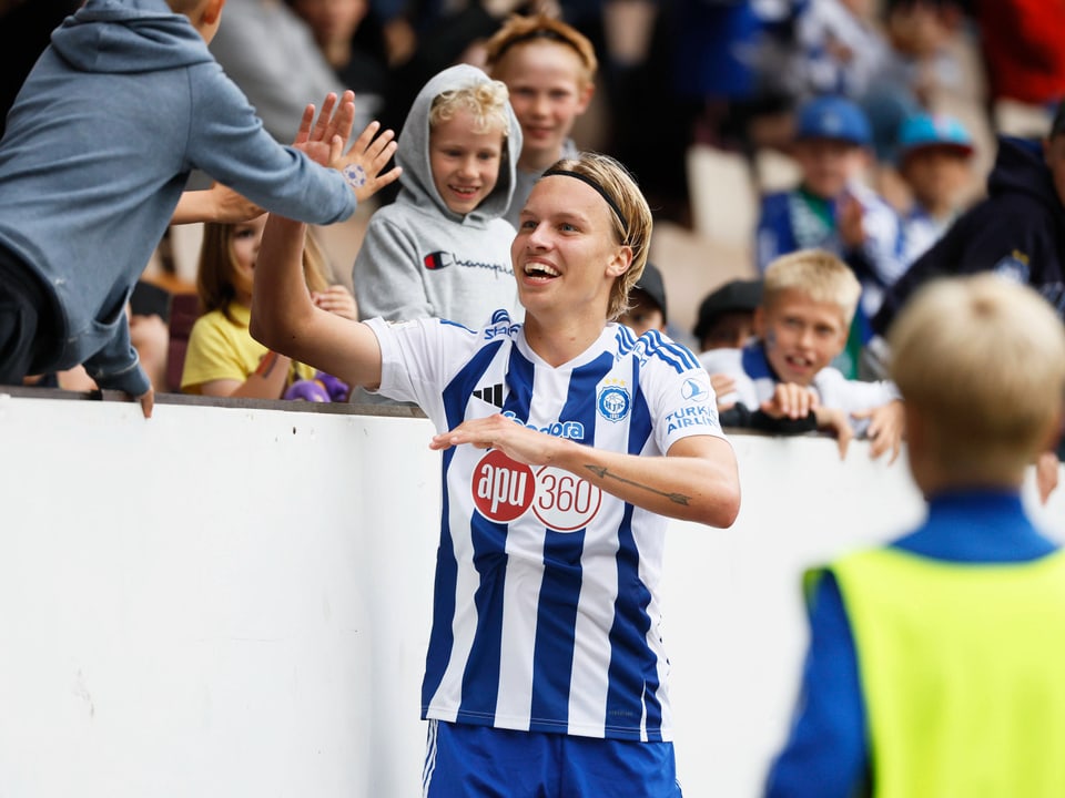 Fussballspieler gibt einem Fan ein High-Five.