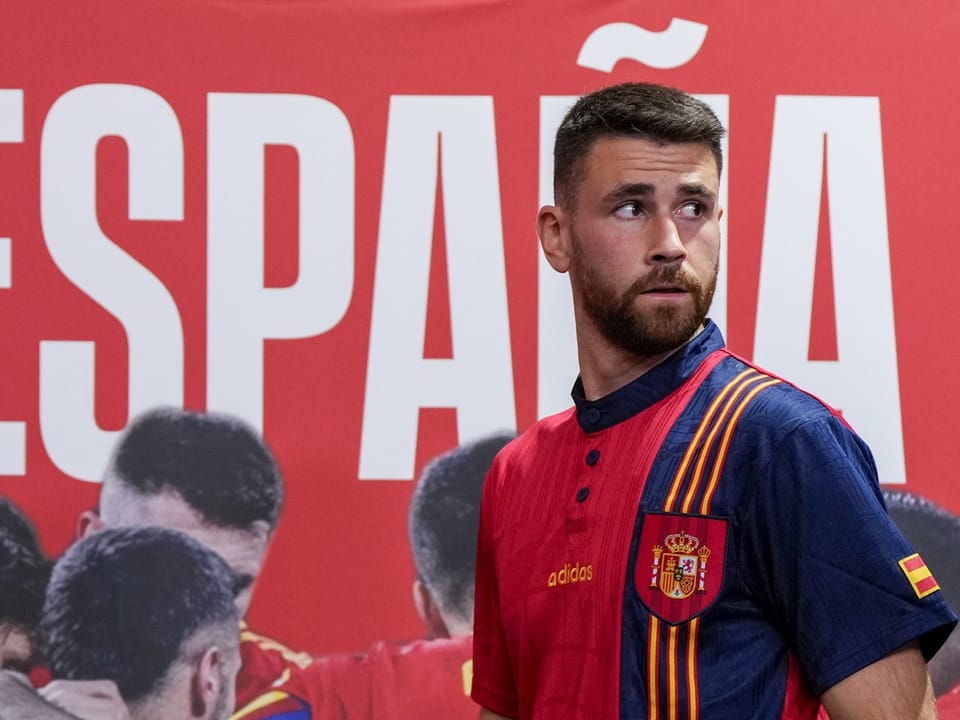 Mann im spanischen Fussballtrikot vor ESPAÑA-Schriftzug.