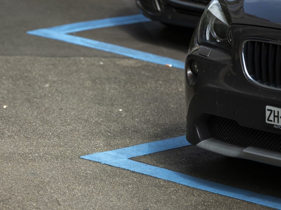 Teilweise sichtbare Autos auf Parkplätzen von Blauen Zonen.