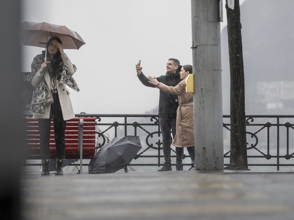 Menschen mit Regenschirmen an einem regnerischen Tag.