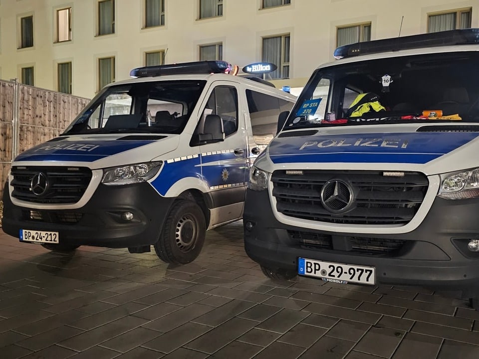 Two police vehicles are parked.