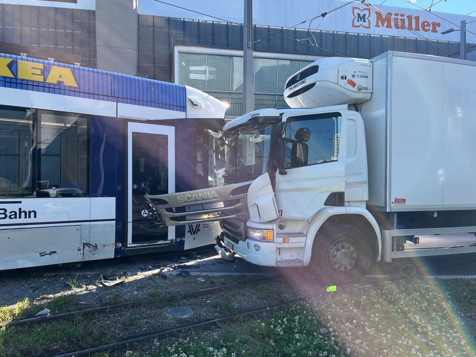 Ein Tram und ein Lastwagen, die frontal kollidiert sind. 