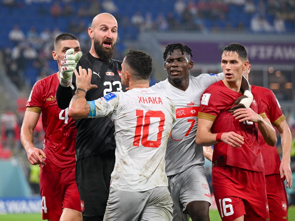 Fussballspieler in Diskussion auf dem Spielfeld.