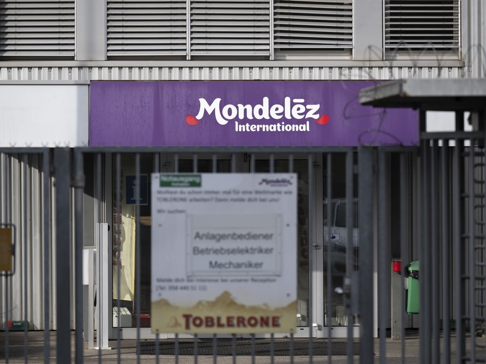 Eingang zum Gebäude von Mondeléz International hinter einem Zaun.