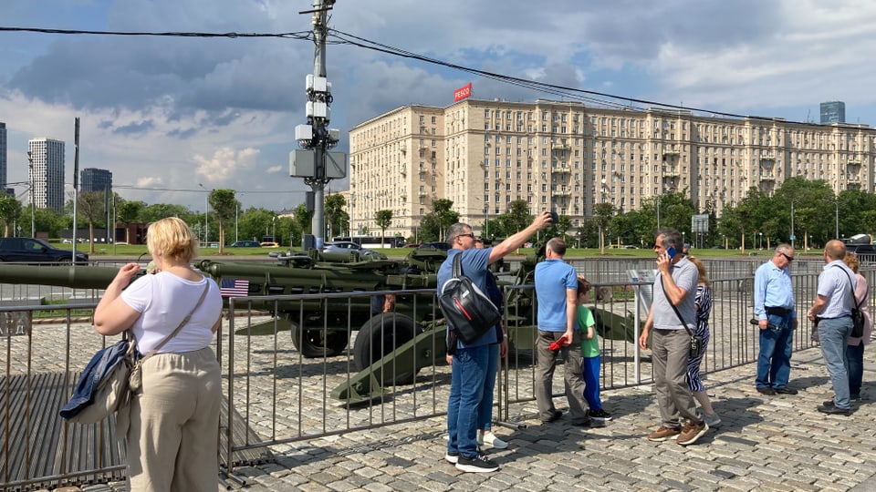 A man takes a selfie with a tank